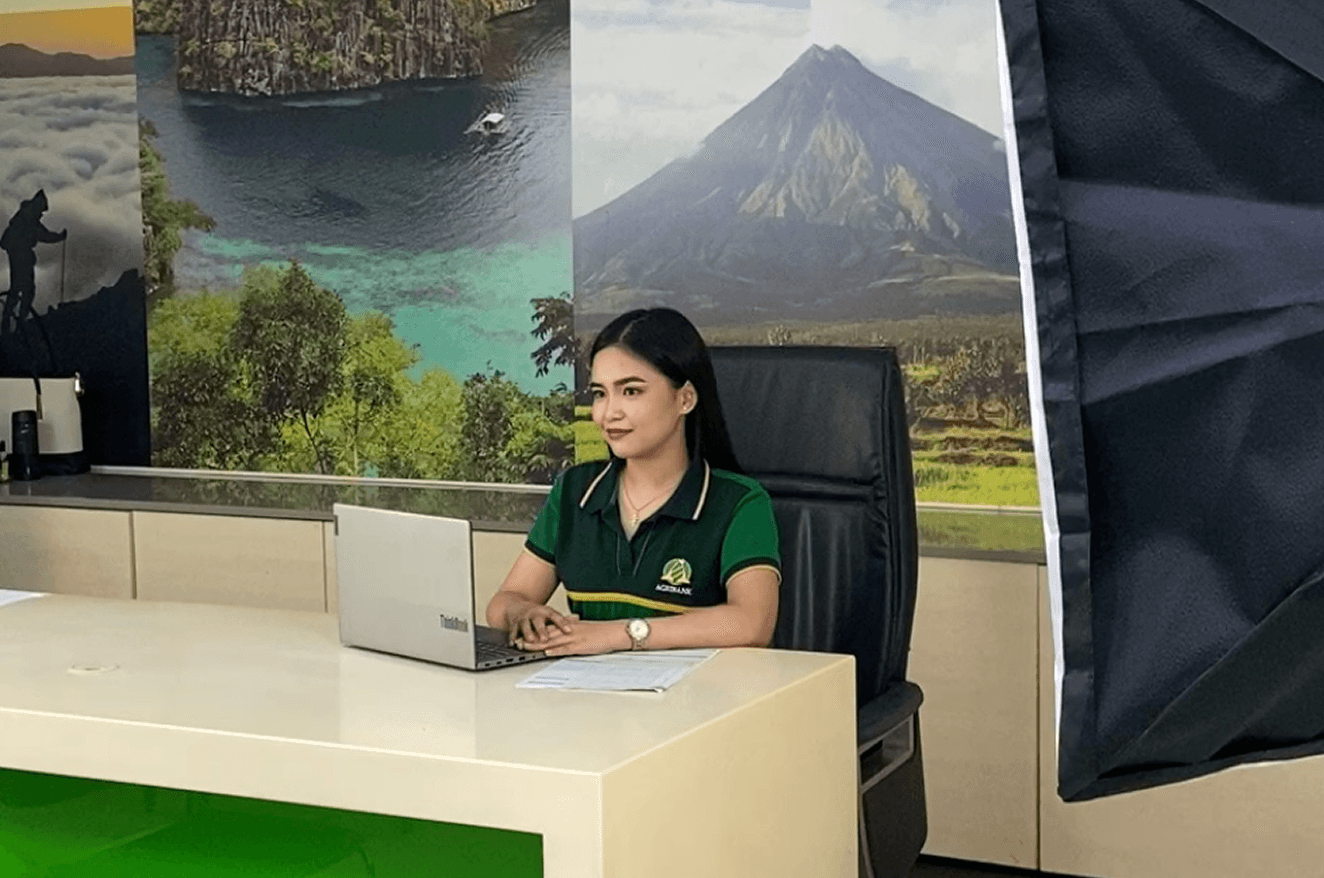 Aljoy in the office infront of her laptop.